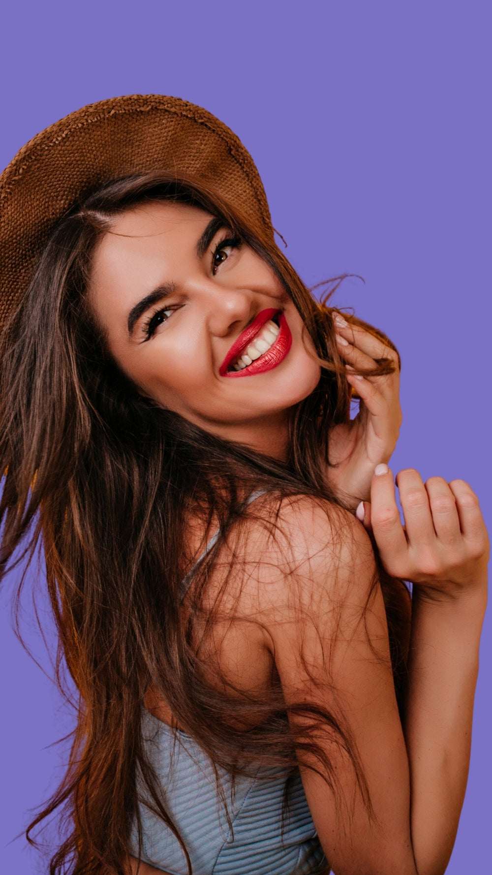 Glowmedik model wearing a straw hat against a purple background