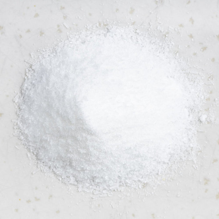White powdery substance representing MSM on a light gray background