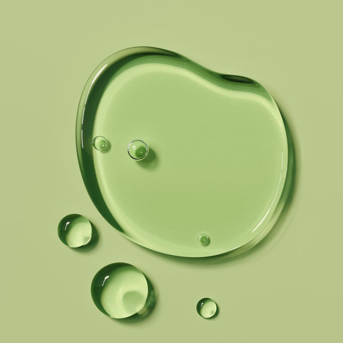 Green liquid droplets on a green background representing Pathenol Pro Vitamin B5