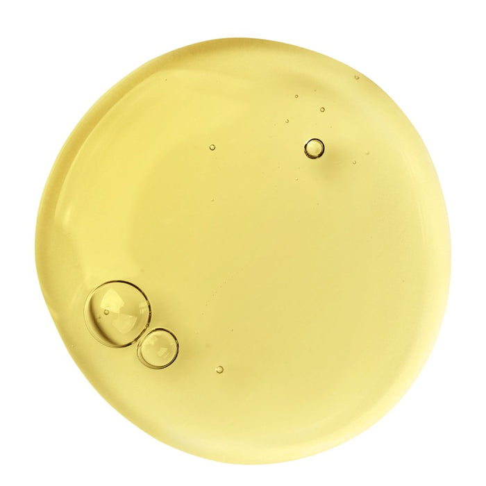 Round gold object with a textured surface on a white background representing retinol vitamin A